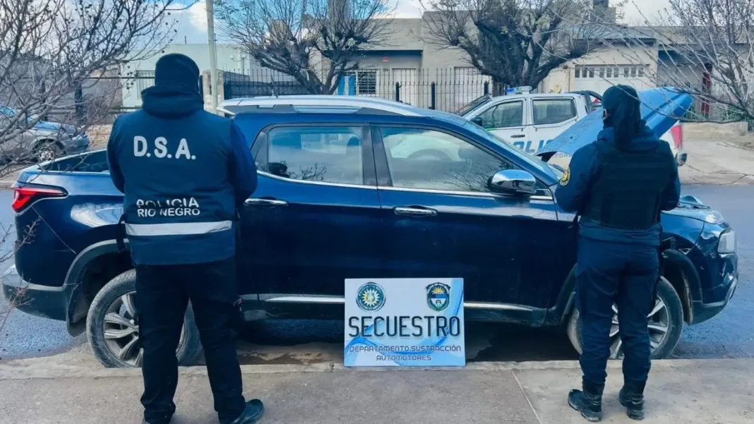 Efectivos de la Policía de Río Negro junto a una camioneta azul secuestrada por el Departamento Sustracción Automotores